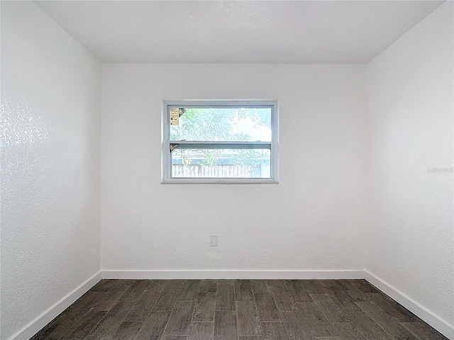 spare room featuring dark hardwood / wood-style flooring