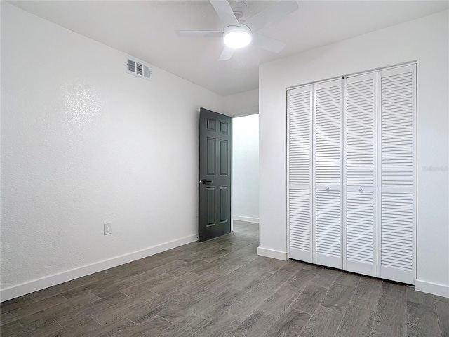 unfurnished bedroom with hardwood / wood-style flooring, ceiling fan, and a closet