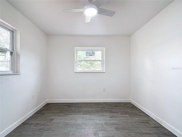 spare room featuring dark hardwood / wood-style floors, a wealth of natural light, and ceiling fan