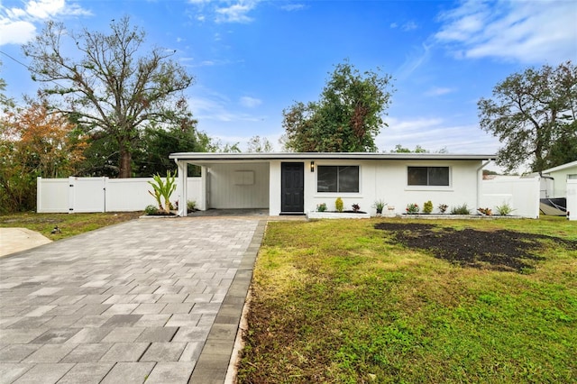 ranch-style house with a carport and a front lawn