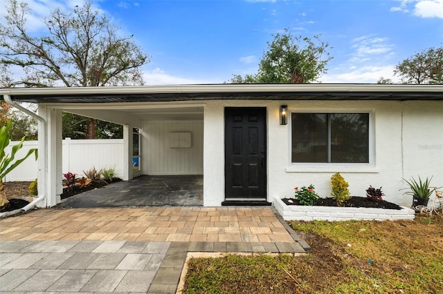 doorway to property featuring a carport