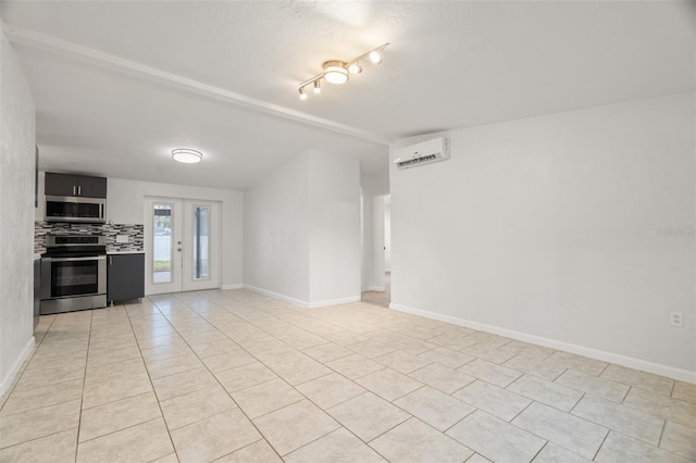 spare room featuring french doors, beam ceiling, light tile patterned flooring, and a wall unit AC