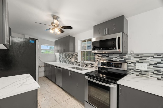 kitchen featuring sink, gray cabinets, ceiling fan, appliances with stainless steel finishes, and light tile patterned flooring