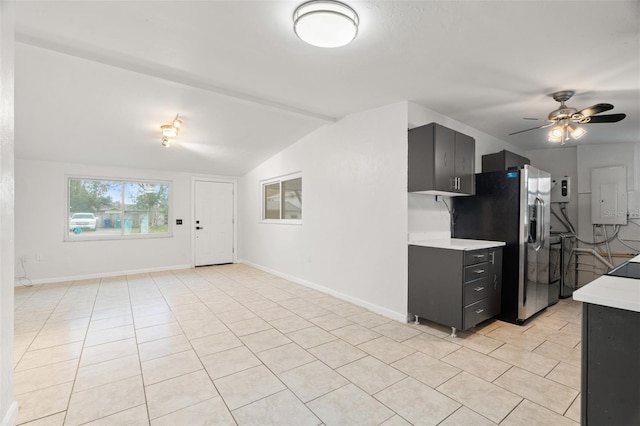 kitchen with stainless steel fridge with ice dispenser, vaulted ceiling with beams, light tile patterned floors, and ceiling fan