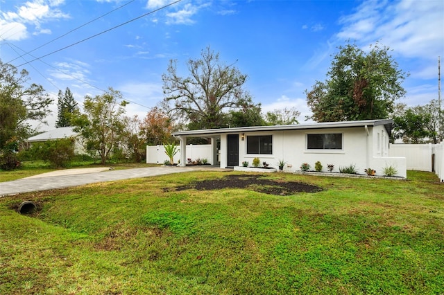 ranch-style house featuring a front yard and a carport