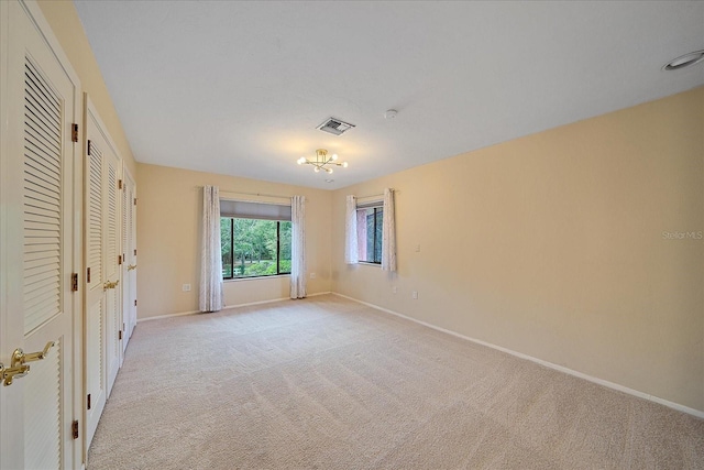 unfurnished bedroom featuring light colored carpet