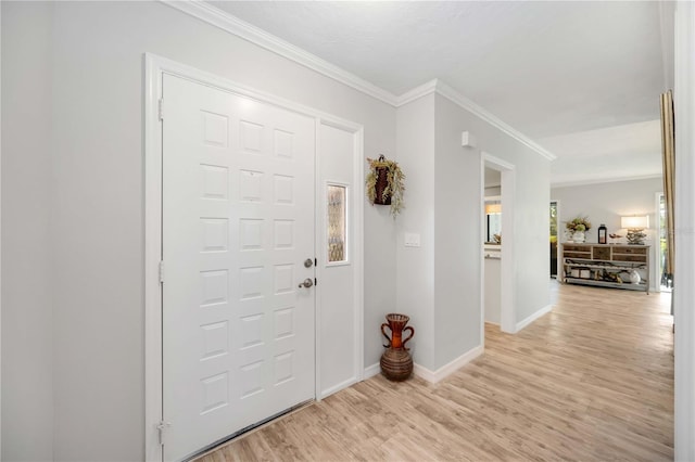 foyer featuring ornamental molding and light hardwood / wood-style flooring