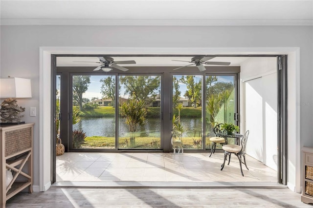 doorway featuring a water view and ornamental molding