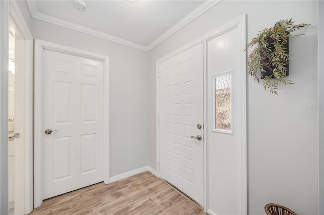 foyer featuring ornamental molding and light hardwood / wood-style floors