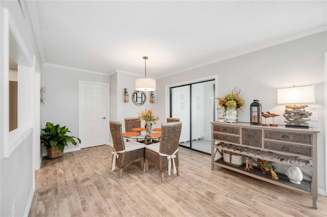 dining room featuring ornamental molding and light hardwood / wood-style flooring