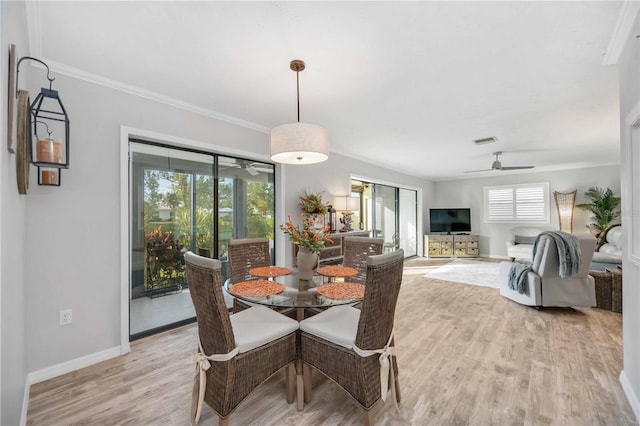 dining room featuring ceiling fan, crown molding, light hardwood / wood-style flooring, and a healthy amount of sunlight