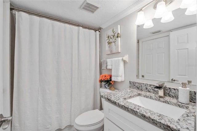 bathroom with vanity, crown molding, and toilet