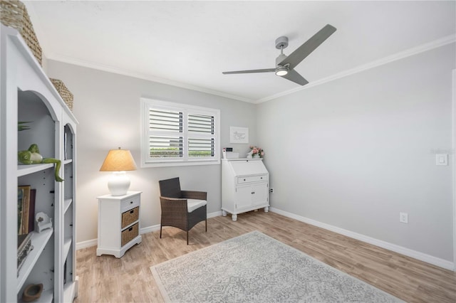 sitting room with crown molding, light hardwood / wood-style floors, and ceiling fan