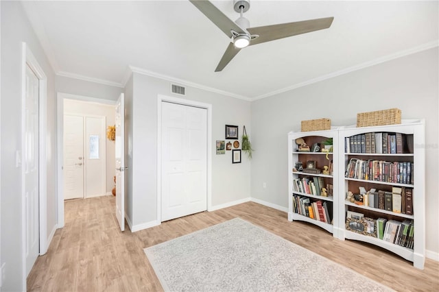 sitting room featuring ornamental molding, ceiling fan, and light hardwood / wood-style flooring