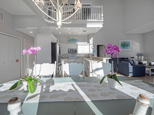 dining area with a towering ceiling