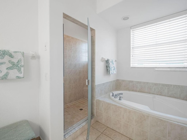 bathroom featuring shower with separate bathtub and tile patterned floors