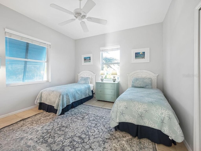 tiled bedroom with ceiling fan