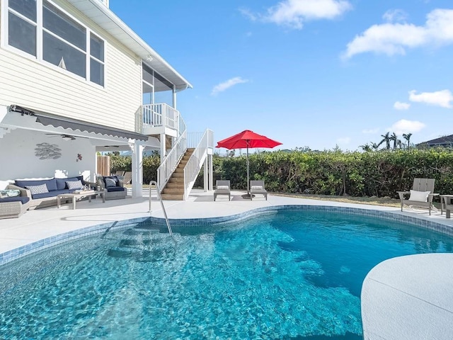 view of swimming pool with an outdoor living space and a patio