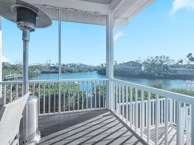 unfurnished sunroom featuring a water view