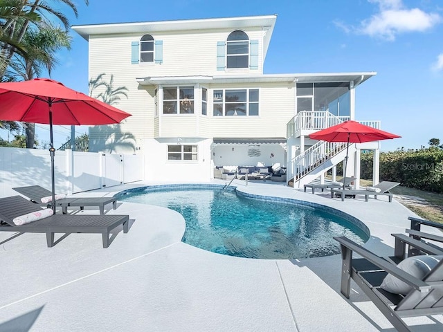 view of pool featuring a sunroom and a patio