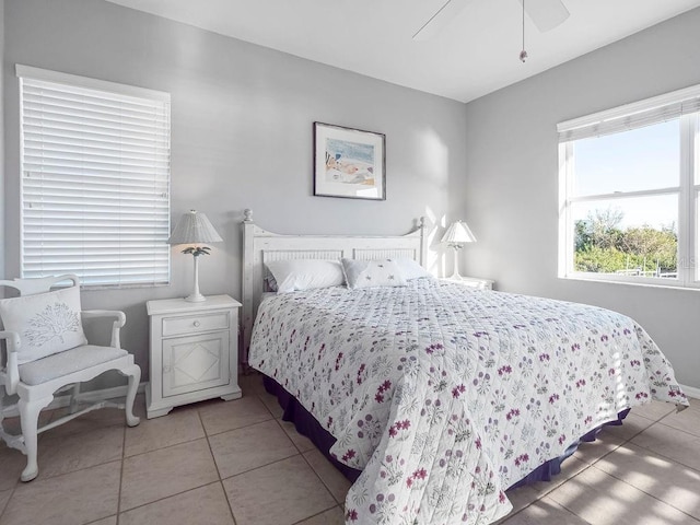 tiled bedroom featuring ceiling fan