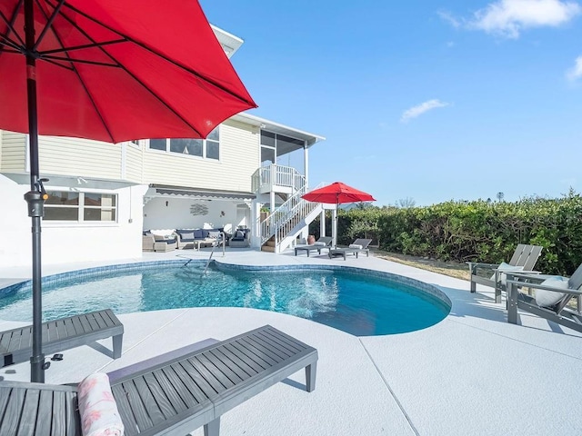 view of swimming pool with outdoor lounge area and a patio