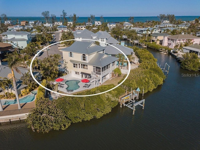 bird's eye view featuring a water view and a residential view