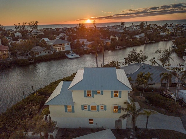 aerial view at dusk with a water view