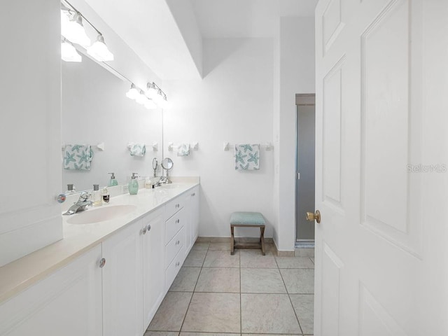 114 Gull Dr, Anna Maria, FL 34216 - bathroom featuring double vanity, tile patterned floors, and baseboards