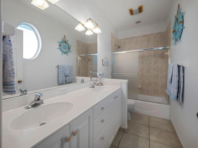 114 Gull Dr, Anna Maria, FL 34216 - bathroom featuring tile patterned floors, toilet, shower / bath combination with glass door, and double vanity