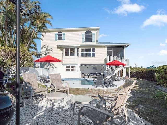 114 Gull Dr, Anna Maria, FL 34216 - rear view of house with a sunroom, a patio, and stairs