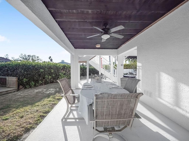 114 Gull Dr, Anna Maria, FL 34216 - view of patio / terrace featuring a ceiling fan, stairs, and outdoor dining space