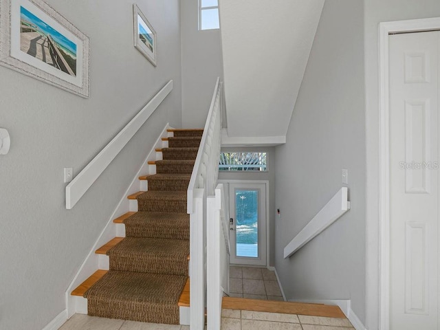 114 Gull Dr, Anna Maria, FL 34216 - stairway with tile patterned flooring and baseboards