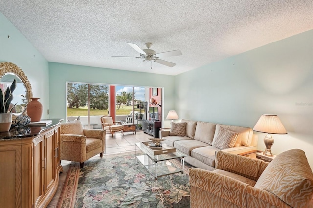 tiled living room featuring ceiling fan and a textured ceiling