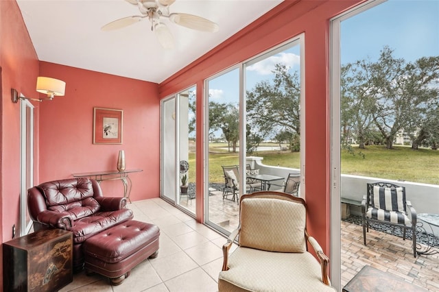 sunroom / solarium featuring ceiling fan