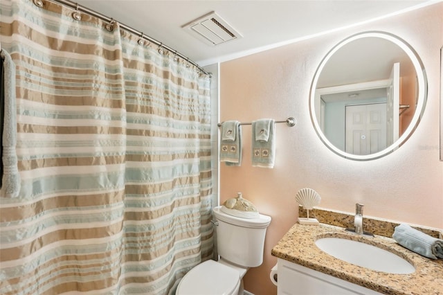 bathroom with vanity, crown molding, and toilet