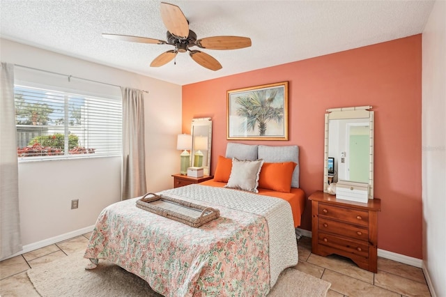 tiled bedroom with a textured ceiling and ceiling fan