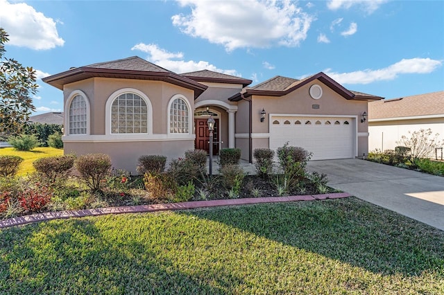 mediterranean / spanish-style home with a garage and a front lawn