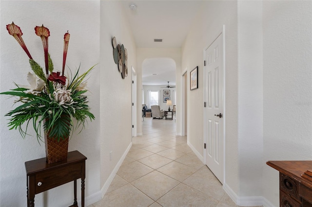 hall with light tile patterned floors