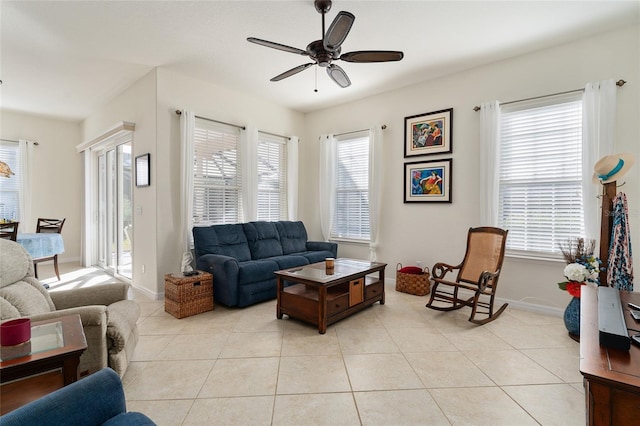 tiled living room with a wealth of natural light and ceiling fan