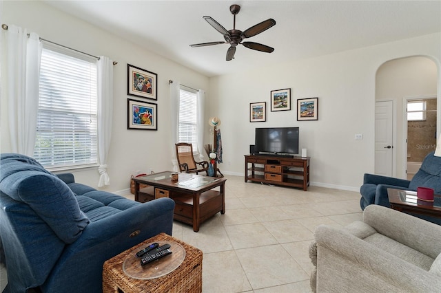 tiled living room with ceiling fan and a healthy amount of sunlight