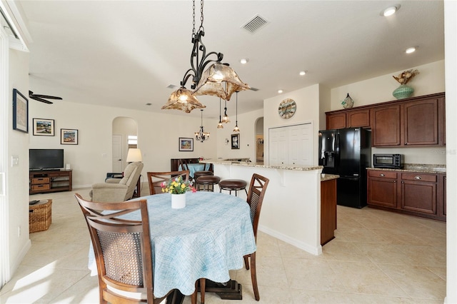 tiled dining area featuring ceiling fan