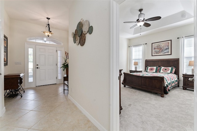 tiled foyer with ceiling fan and a healthy amount of sunlight