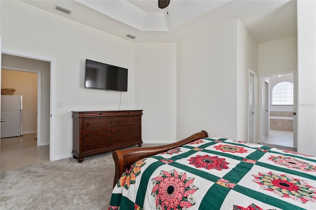 carpeted bedroom with ceiling fan and white fridge