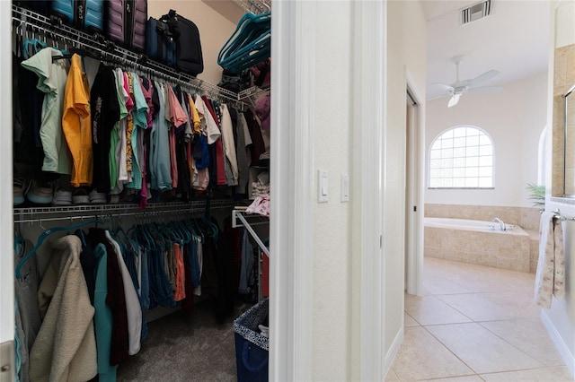 spacious closet with tile patterned flooring and ceiling fan