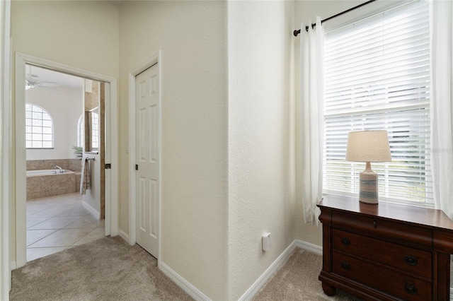 hall with light tile patterned floors