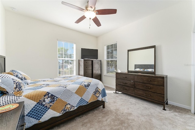 bedroom featuring ceiling fan and light carpet