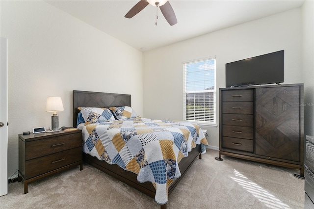 bedroom featuring ceiling fan and light carpet