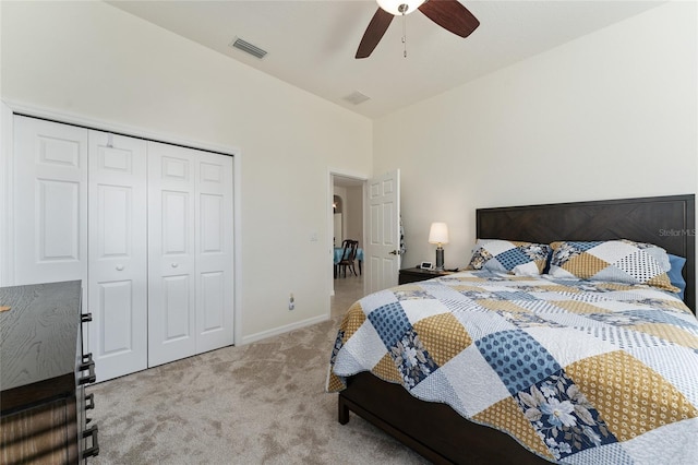 bedroom with light colored carpet, a closet, and ceiling fan