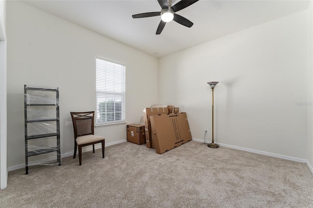 living area featuring ceiling fan and light carpet